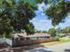 View of the backyard with privacy fence, green grass, and mature trees providing shade at 509 Stone Dr, Brandon, FL 33510