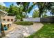 Spacious backyard with a patio area, lush greenery, and a privacy fence at 509 Stone Dr, Brandon, FL 33510