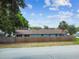 View of the backyard with privacy fence, green grass, and mature trees providing shade at 509 Stone Dr, Brandon, FL 33510