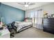 Cozy bedroom with blue accent wall features ceiling fan, and ample natural light from the window at 509 Stone Dr, Brandon, FL 33510