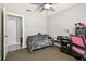 Neutral-colored bedroom with a ceiling fan, a door, and a futon for space-saving functionality at 509 Stone Dr, Brandon, FL 33510