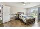 Comfortable bedroom with wood flooring and natural light features a ceiling fan and access door at 509 Stone Dr, Brandon, FL 33510