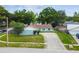 Charming single-story home with a blue exterior, brown roof, mature trees, and a spacious front yard at 509 Stone Dr, Brandon, FL 33510