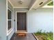 Charming front entrance with a 'Welcome' mat, textured walls, and window for natural light at 509 Stone Dr, Brandon, FL 33510