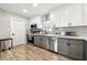 Newly renovated kitchen with gray and white cabinets, stainless steel appliances, and modern backsplash at 509 Stone Dr, Brandon, FL 33510