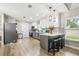 Open concept modern kitchen with breakfast bar, stainless steel appliances, and sleek gray and white cabinets at 509 Stone Dr, Brandon, FL 33510