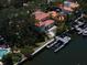 Aerial view of waterfront home and private dock along a canal with meticulous landscaping at 514 Riviera Dr, Tampa, FL 33606