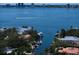 Aerial view of waterfront homes along a canal leading to a bay with city skyline in the distance at 514 Riviera Dr, Tampa, FL 33606