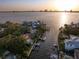 Aerial view of waterfront homes along a canal with the city skyline in the distance at 514 Riviera Dr, Tampa, FL 33606
