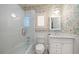Stylish bathroom with map-themed wallpaper, white subway tile, and glass shower door at 514 Riviera Dr, Tampa, FL 33606