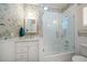 Charming bathroom with unique wallpaper, marble vanity, and a glass enclosed tub at 514 Riviera Dr, Tampa, FL 33606