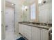 Elegant bathroom featuring a double vanity, marble countertops, and a glass shower at 514 Riviera Dr, Tampa, FL 33606