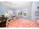 Bright bedroom featuring hardwood floors, shuttered windows, a ceiling fan and vintage furnishings at 514 Riviera Dr, Tampa, FL 33606