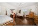 Charming bedroom features hardwood floors, vintage furniture, and ample natural light at 514 Riviera Dr, Tampa, FL 33606