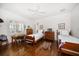 Comfortable bedroom features hardwood floors, ceiling fan, and natural light at 514 Riviera Dr, Tampa, FL 33606