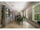 Elegant dining room featuring patterned wallpaper, chandelier, and green upholstered chairs at 514 Riviera Dr, Tampa, FL 33606