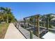 Private boat dock featuring a boat lift and a walkway with lush landscaping at 514 Riviera Dr, Tampa, FL 33606