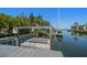 Private boat dock featuring a boat lift and a walkway with deep water access at 514 Riviera Dr, Tampa, FL 33606