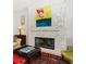 Close-up of a modern fireplace featuring a stone surround and eye-catching artwork above at 514 Riviera Dr, Tampa, FL 33606