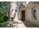Welcoming front entrance with a decorative archway, lantern fixture, and tiled pathway at 514 Riviera Dr, Tampa, FL 33606