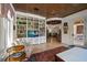 Inviting living room with built-in bookshelves, coffered ceiling, and access to the outside at 514 Riviera Dr, Tampa, FL 33606