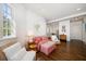 Cozy living room with hardwood floors, natural light, and wicker furniture at 514 Riviera Dr, Tampa, FL 33606