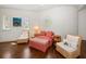 Cozy sitting area with hardwood floors, natural light, and wicker furniture at 514 Riviera Dr, Tampa, FL 33606