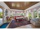 Cozy living room with coffered ceilings, unique window trim and a large oriental rug with bright sofas at 514 Riviera Dr, Tampa, FL 33606