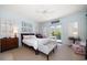 Bright bedroom with balcony access, plantation shutters, and soft blue walls at 514 Riviera Dr, Tampa, FL 33606