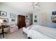 Light-filled bedroom featuring a sitting area, a classic dresser, and ample wall decor at 514 Riviera Dr, Tampa, FL 33606