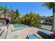 Inviting backyard pool and spa surrounded by lush tropical landscaping and a dock for accessing the water at 514 Riviera Dr, Tampa, FL 33606