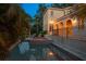 Backyard pool and patio area featuring a heated spa and poolside lounge chairs at twilight at 514 Riviera Dr, Tampa, FL 33606