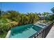 Gorgeous pool and spa surrounded by palm trees and water views at 514 Riviera Dr, Tampa, FL 33606
