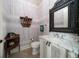 Stylish powder room with detailed wallpaper, a unique mirror, and a marble-topped vanity at 514 Riviera Dr, Tampa, FL 33606