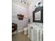 Chic powder room with decorative wallpaper, ornate mirror, and marble vanity at 514 Riviera Dr, Tampa, FL 33606