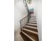 Beautiful staircase with hardwood treads, white risers, and black iron railing at 514 Riviera Dr, Tampa, FL 33606