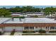 Aerial view of home showing roof, garage, and surrounding trees in established neighborhood at 602 Mindy Dr, Largo, FL 33771