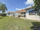 Lush backyard with a patio area ideal for BBQs with a well-maintained yard and fence at 602 Mindy Dr, Largo, FL 33771