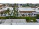 An aerial view of a home's backyard featuring a cozy patio area with outdoor seating and lush landscaping at 602 Mindy Dr, Largo, FL 33771