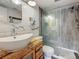 Modern bathroom with wood-look tile floors, a floating vanity, and a glass-enclosed shower at 602 Mindy Dr, Largo, FL 33771