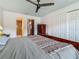 Bedroom featuring wood-look tile flooring, ceiling fan, closet, and en-suite bathroom at 602 Mindy Dr, Largo, FL 33771