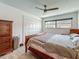 Bedroom with wood-look tile flooring, a ceiling fan, and traditional-style furniture at 602 Mindy Dr, Largo, FL 33771