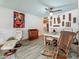 Unique dining room featuring wood-look tile floors, an eclectic art collection, and a mix of modern and rustic furniture at 602 Mindy Dr, Largo, FL 33771