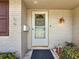 Close-up of the front door area, showing a storm door, mailbox, and exterior light fixture at 602 Mindy Dr, Largo, FL 33771