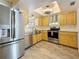 Bright kitchen with stainless steel appliances, farmhouse sink, and rustic wood cabinetry at 602 Mindy Dr, Largo, FL 33771
