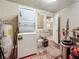 Functional laundry room with washer, dryer, and utility sink, leading to the kitchen at 602 Mindy Dr, Largo, FL 33771