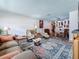 Spacious living room area with comfortable seating, stylish rug, and views into dining area at 602 Mindy Dr, Largo, FL 33771