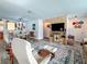 Open-concept living room featuring a large TV, wood-accented wall, and comfortable seating at 602 Mindy Dr, Largo, FL 33771