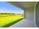 Back porch overlooking a lush green lawn and serene pond view, blending indoor and outdoor living at 6126 Hidden Branch Dr, Apollo Beach, FL 33572