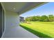 Covered lanai with view of large backyard, screened pool, and lush greenery at 6126 Hidden Branch Dr, Apollo Beach, FL 33572